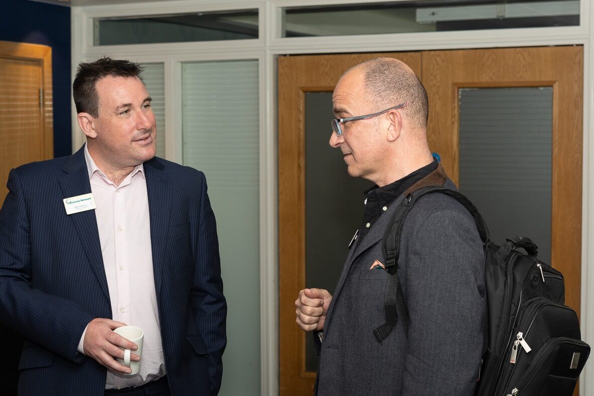 Glenn Cameron talking to member at event